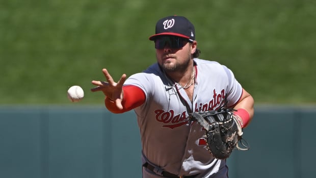 Washington Nationals 1B Luke Voit throws to first base